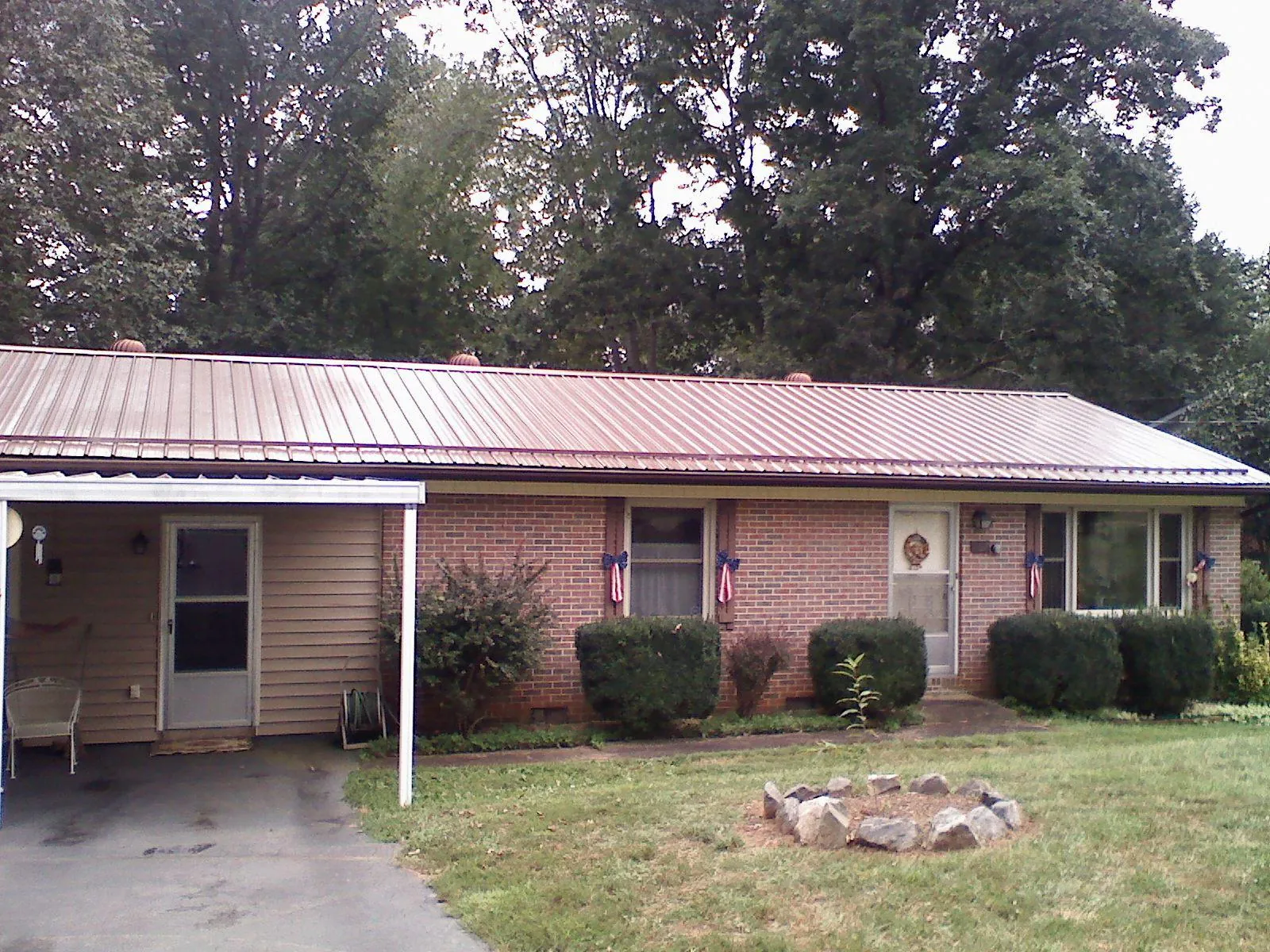 Bronze metal roof and carport on a brick ranch home — Roof Repair work by our crew in New Plymouth